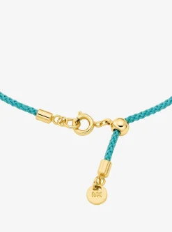 Bracelet en cordon avec logo doré à pierres pavées